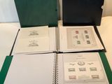 three green binders are sitting on top of a white table