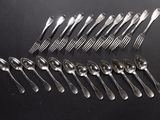 a lot of spoons and forks on the table