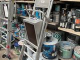 many cans of paint on the shelves in the store