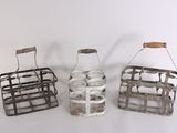 three small metal baskets with wooden handles on a white surface