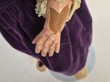 a person that is holding a doll in their hand