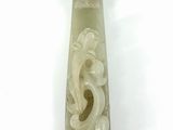 jade carving of a dragon on a white background