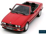 red model of a car with a black top on a white surface