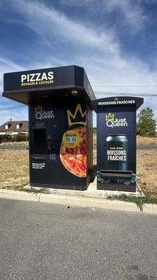 a black box with a pizza on it sitting on the side of the road