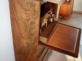 a wooden cabinet with a marble top in a room