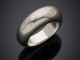 a close up of a silver ring on a black surface