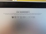 the back of a laptop computer with a bar code on it