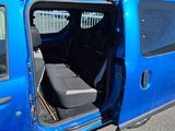 a blue van with its doors open on the street
