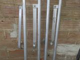 four metal pipes that are attached to a brick wall