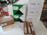 boxes of laser toner and printer paper on a table in a room
