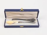 a silver spoon and fork in a blue box