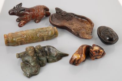 five pieces of carved animal figurines sitting on a table
