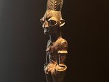 statue d'un homme coiffé d'un chapeau, posée sur une table en bois