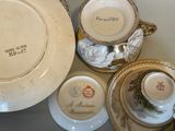 a lot of plates and cups that are on the table