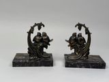 pair of antique bronze figurines of a woman and a man
