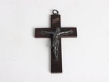 a close up of a cross on a white surface with a white background