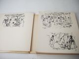 two open books with drawings on them on a table