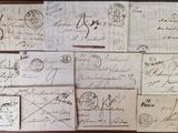 many old envelopes on the table with writing on them