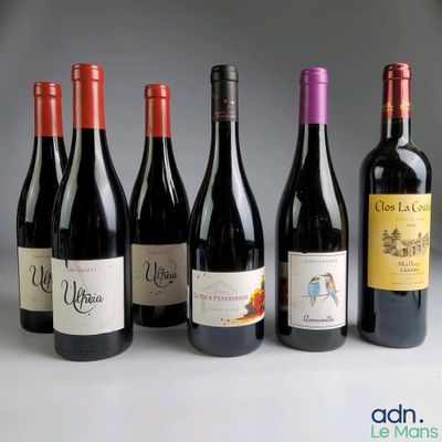 several bottles of wine are lined up in a row on a table