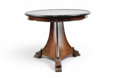 a round table with a glass top and wooden legs