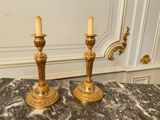 pair of antique brass candlesticks on a marble table