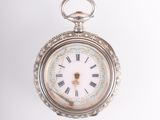 a silver pocket watch with roman numerals on the face