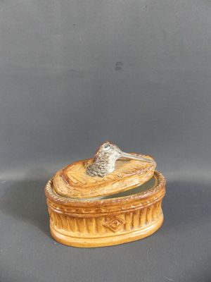 a small wooden box with a bird on top of it