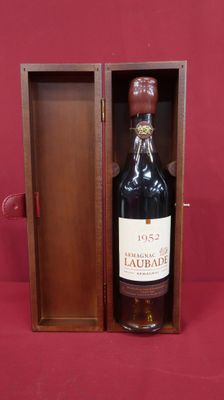 a bottle of wine in a wooden box on a red surface