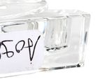 a glass bottle with a label on it with a sticker attached to it