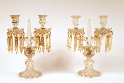 pair of clear glass candelabs with candlesticks on stands