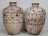 two vases sitting side by side on a table