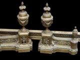 pair of antique brass candlesticks on a black background