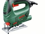 a green and black electric jig saw sitting on top of a table