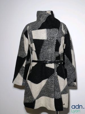 an image of a black and white coat on a mannequin