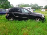 a black suv that is parked in the grass