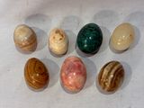 six different types of marbles on a white surface