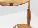 an image of a brass lamp with a wooden base on a white surface