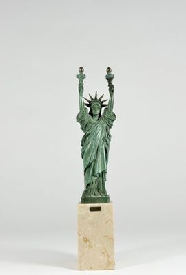 the statue of liberty is standing on a marble pedestal