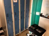two lockers in a room with a cart in front of them