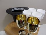 two wine glasses and a hat on a table