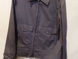 an image of a jacket hanging on a hanger on a wall