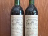 two bottles of wine sitting on a table