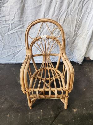 an image of a wicker chair sitting on top of a cement floor