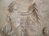 a statue of a woman holding a bird in her hand