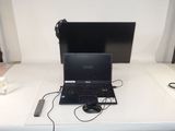 a laptop computer sitting on top of a white table