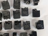 a lot of different types of metal parts on a white surface