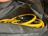 a person holding a bag with a bunch of cords inside of it