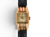 an image of a close up of a wrist watch on a white surface