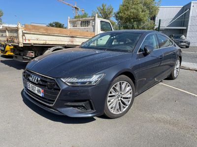 the new audi sedan is parked in front of a truck