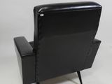 the back of a black leather recliner chair against a white background